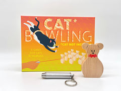 Finally, a game to play with your cat.
It’s as simple as pins, point, pounce! With Cat Bowling, let your cat be the bowling ball as you try to bowl the perfect game. A wonderful tool for spending quality time with your ferocious fur ball and the purr-fect gift for cat lovers (that they don’t already have ten of).
Cat Bowling comes with 10 solid wood mouse bowling pins and a laser pointer. Batteries included.