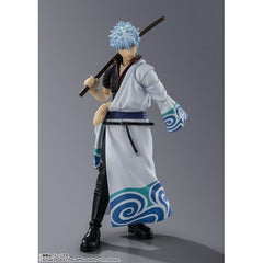 To celebrate the 20th anniversary of "Gintama", SAKATA GINTOKI is now available as an S.H.Figuarts! Reproduce the various expressions of the charming Gintoki with 3 types of Interchangeable expression parts in addition to the standard expression. In addition, a variety of scenes can be reproduced with 3 types of interchangeable hand parts. His signature "hands-in-pocket" pose can also be recreated with the optional hand parts. His beloved sword "Toyako" is also included.