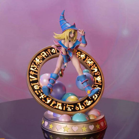 This statue has no edition number, and was a replacement and is in new and unopened condition.
The “Pastel” variation features Dark Magician Girl wearing a light blue dress accented by light pink details. For the exclusive edition, the Magician’s seal lights up with 2 LED functions: Static and Animated. When animated, lights swirl around the ring of the Seal as if Dark Magician Girl is preparing to use her Dark Burning Attack!