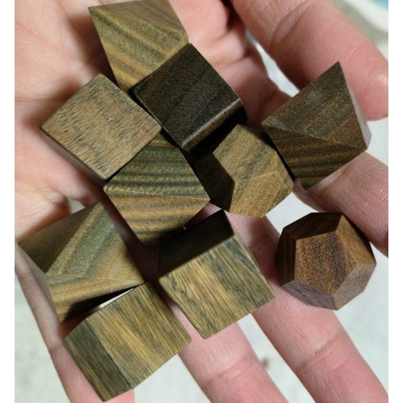 The perfect companion for your gaming needs! These premium, high-end cut wood polyhedral dice are exactly what you've been searching for that upcoming game night with the group.They are stored in a quality, brushed metal tin with foam insert. These dice are a rich quality wood with nice weight to them and engraved each with crisp, easy-to-read numerals. Many styles and colors are available.
This set includes on of each: d20, d12, d10, d10 (percentile), d8, d6, and a d4 (7 dice in total). All inside the Gal