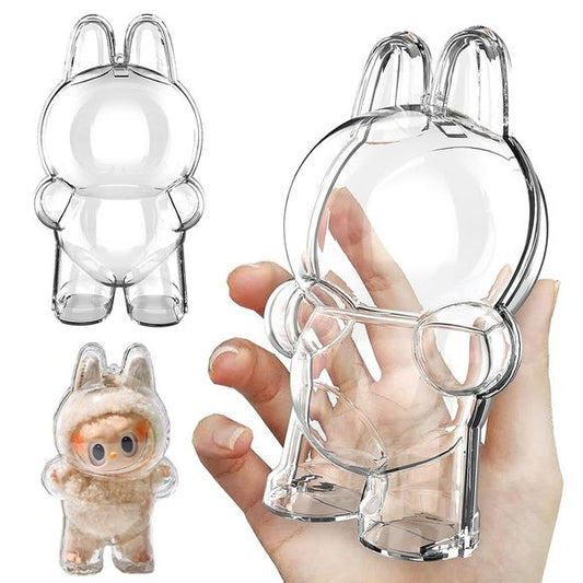Labubu Clear Protective Case Cover, Standing Version – crystal-clear shell for Labubu plush and vinyl figures. Keep your Labubu safe and looking adorable wherever you go with this crystal-clear protective shell, shaped specifically to fit Labubu's iconic silhouette (bunny ears and rounded body included) in the standing pose.
Made from sturdy, transparent plastic to shield your plush from dirt, dust, scratches, and light rain — lightweight yet strong enough to clip to backpacks, bags, or display shelves. Fu