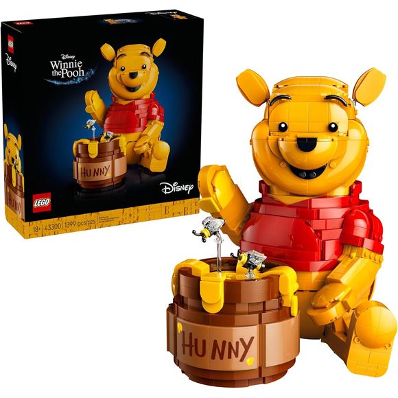 Celebrate 100 years of childhood magic with the LEGO Disney Winnie the Pooh (43300) display model building kit for adults ages 18 and up. This charming commemorative set brings the beloved bear to life with a brick-built, classic Winnie the Pooh character featuring a movable head, ears, arms and hands, plus a buildable honey pot. The brick-built model also holds a delightful surprise: open the 'Hunny' pot to reveal 2 hidden rooms with a Winnie the Pooh minifigure and an Eeyore figure tucked inside. Packed w