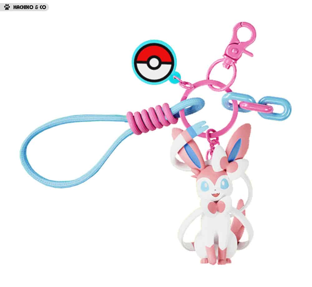 Add a touch of Fairy-type elegance to your everyday accessories with this adorable Sylveon Charm Keychain by Langbowang! Featuring Sylveon in a cute chibi-style design, complete with its signature ribbon-like feelers and pastel pink-and-blue color palette, this charming accessory is perfect for Pokémon fans who love one of the most beloved Eeveelutions.
The keychain includes a detailed Sylveon figure, a Poké Ball charm, colorful decorative links, and a convenient wrist loop attachment for easy carrying. Wh