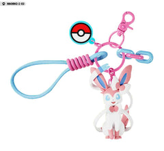 Add a touch of Fairy-type elegance to your everyday accessories with this adorable Sylveon Charm Keychain by Langbowang! Featuring Sylveon in a cute chibi-style design, complete with its signature ribbon-like feelers and pastel pink-and-blue color palette, this charming accessory is perfect for Pokémon fans who love one of the most beloved Eeveelutions.
The keychain includes a detailed Sylveon figure, a Poké Ball charm, colorful decorative links, and a convenient wrist loop attachment for easy carrying. Wh