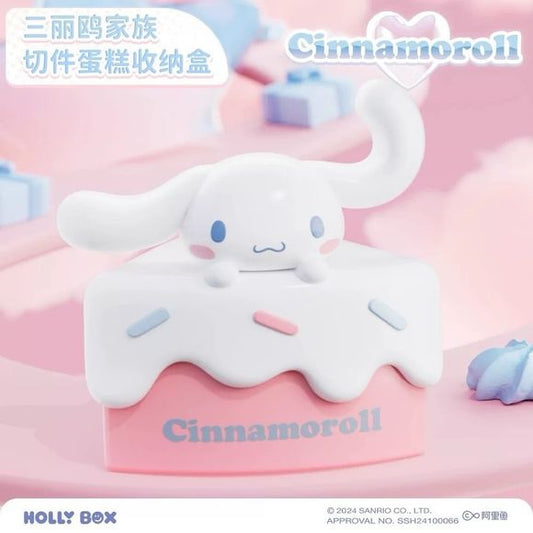 Add a touch of sweetness to your space with the Cinnamoroll Cake Slice Storage Box from Holly Box! This adorable collectible combines cute Sanrio styling with practical storage, featuring Cinnamoroll relaxing atop a pastel cake slice decorated with colorful frosting and candy sprinkles.
Lift the top to reveal a hidden storage compartment perfect for holding small accessories, jewelry, coins, desk essentials, or other tiny treasures. The soft pink and white color palette, paired with Cinnamoroll's lovable e