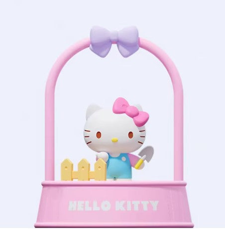 Bring a touch of Sanrio charm and greenery to your home or workspace with the adorable Hello Kitty Afternoon Garden Plant Ornament from Holly Box! This unique collectible features Hello Kitty tending her own miniature garden inside a pastel pink planter display complete with decorative fencing, gardening accessories, and a signature bow accent.
Unlike traditional figures, the Afternoon Garden Series includes seeds that can be planted directly in the display, allowing you to grow your own miniature garden a