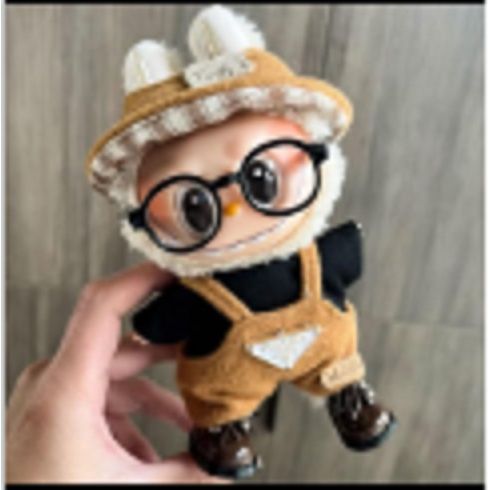 Outfit includes a hat, shirt and overalls perfectly designed to fit your favorite Labubu. Customize and accessorize yours today! Glasses, Shoes and Labubu not included.