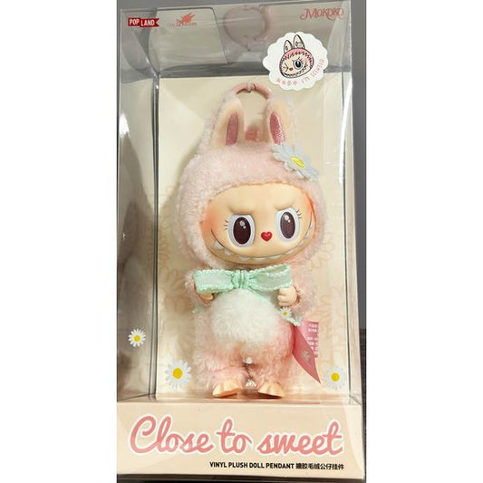 Elevate your collection with Pop Land’s “Mokoko Close to Sweet” Vinyl Plush Doll Pendant—a rare and charming take on the beloved Labubu character. Dressed in pastel pink with bunny features, a signature toothy grin, and a decorative bow, Mokoko is as sweet as she is mischievous. Crafted with plush body and vinyl details, she stands approximately 11–16 cm tall and includes a pendant loop for effortless styling. This pendant is a Pop Land–exclusive, making it a must-have for collectors seeking something both