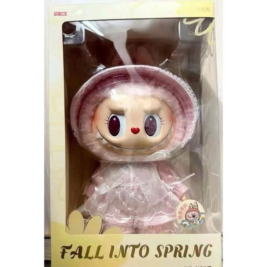 Welcome the new season with the charming Mokoko “Fall Into Spring” Vinyl Plush Doll, a beautifully designed collectible that blends soft pastel elegance with Mokoko’s signature mischievous expression. Featuring her iconic bunny-hood with plush ears, big sparkling eyes, heart-shaped nose, and adorable toothy grin, this special edition brings irresistible personality to your collection.
Dressed in a delicate pink lace dress with layered textures and gentle springtime tones, Mokoko embodies the warmth and ren