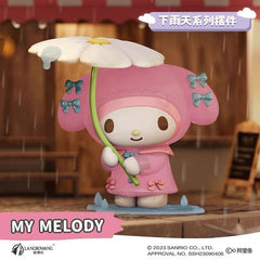 Don't let the rain dampen the fun! The My Melody Rainy Day Series Figure from Langbowang captures Sanrio's beloved bunny enjoying a rainy afternoon in the sweetest way possible. Dressed in a pastel pink raincoat adorned with tiny bow accents, My Melody stands beneath a charming daisy-shaped umbrella while splashing through puddles with a smile.
The warm café-inspired backdrop and detailed rainy-day scene create a cozy atmosphere, while the figure's soft colors and adorable sculpt make it a standout display