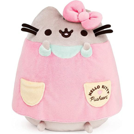 Pusheen and Hello Kitty have partnered up! Pusheen, the snack-loving cat who loves to go on adventures with her friends, and the internationally beloved kawaii little girl from the world of Sanrio have paired up for a best friends-themed collection of extra-special plush, featuring both of their signature styles combined for extra cuteness! This 9.5” plush features Pusheen in a dress made to match her BFF Hello Kitty. Pusheen sports HK’s iconic oversized bow, wearing a pretty pastel pink dress with yellow a