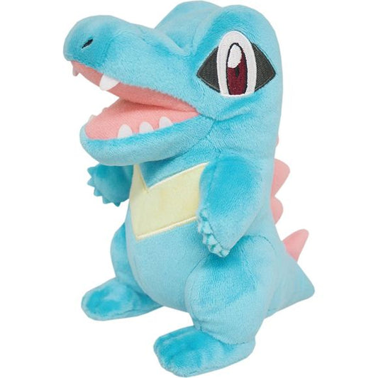 Totodile resembles a bipedal, blue crocodile with red spines on its back and tail. The spine on its back is larger with additional ridges. Totodile's head is large, with ridges above its eyes. Much of the head's size is composed of Totodile's snout and strong jaws.