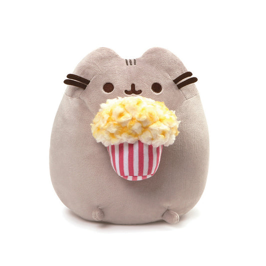 GUND is proud to present Pusheen — a Chubby Gray tabby cat that loves cuddles, snacks, and dress-up. As a popular web comic, Pusheen brings brightness and chuckles to millions of followers in her rapidly growing online fan base. This 9.5” upright plush version of Pusheen has her ready to enjoy a movie with an overflowing bucket of yummy Buttered popcorn! Surface-washable for easy cleaning. Appropriate for ages one and up. About GUND: for more than 100 years, GUND has been a premier plush Company recognized