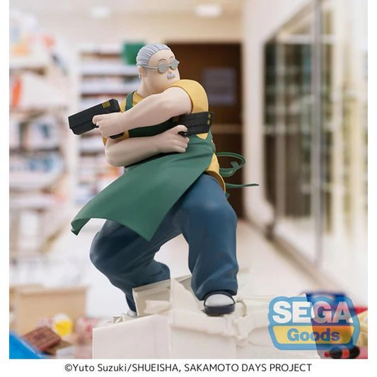 The Luminasta Taro Sakamoto Store Manager Ver. figure captures the character in his dual role as a legendary hitman and convenience store manager. The figure depicts him pulling dual guns while in action pose, wearing work apron attire and positioned on a dynamic base. Approximately 21 cm (8.27 inches).