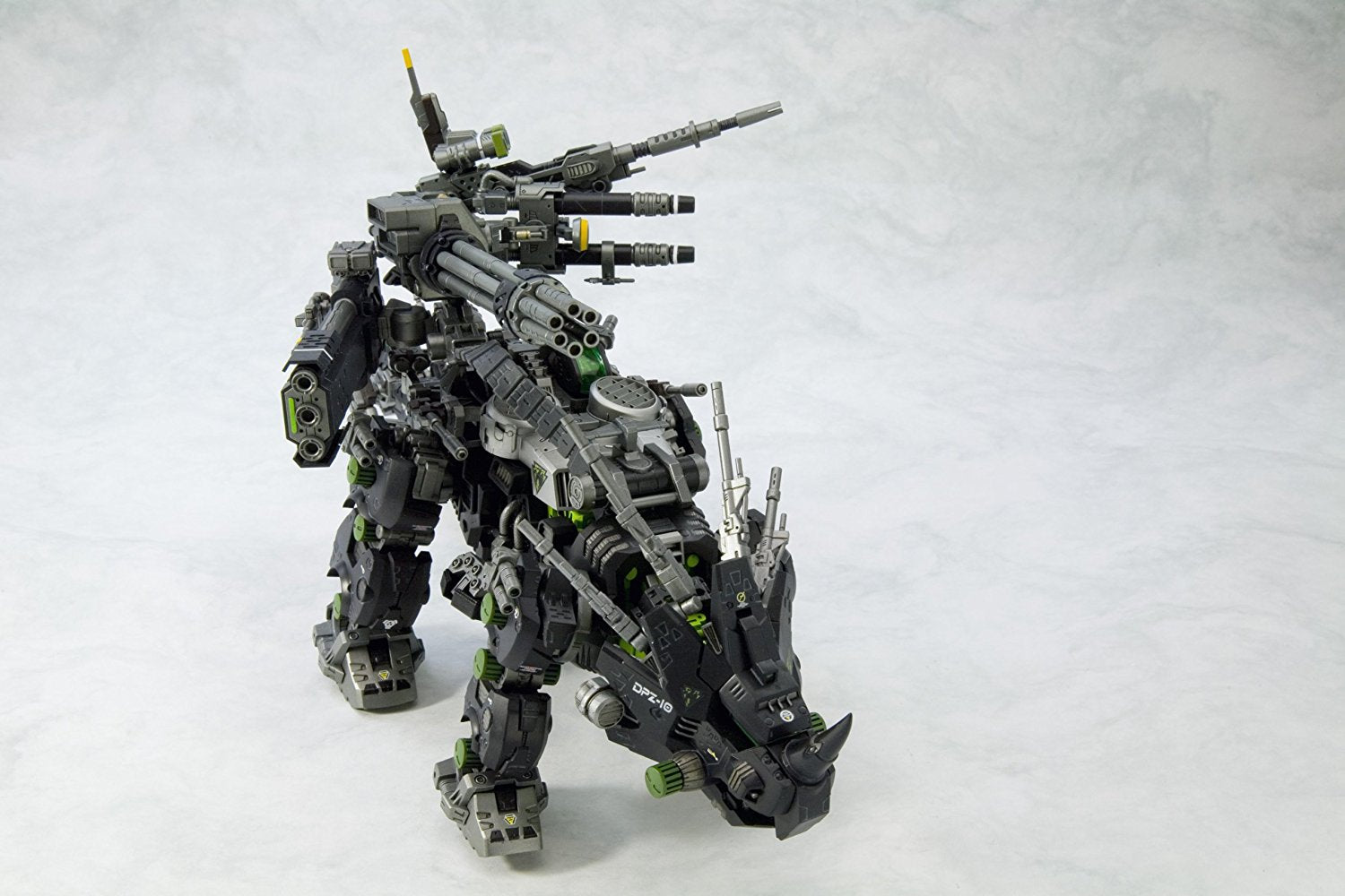 "Based on the popular HMM RED HORN droid, DARK HORN is joining the Kotobukiya’s Zoids line! DARK HORN features a black color scheme that contrasts with the original red, and boasts and an additional weapon on its back! Despite the fact that it is a variation of RED HORN, DARK HORN boasts an impressive level of unparalleled power and strength. The model boasts a black and green color scheme befitting of one of the Guylos Empire’s Dark Zoids. The color division in this multi-colored plastic kit give the model