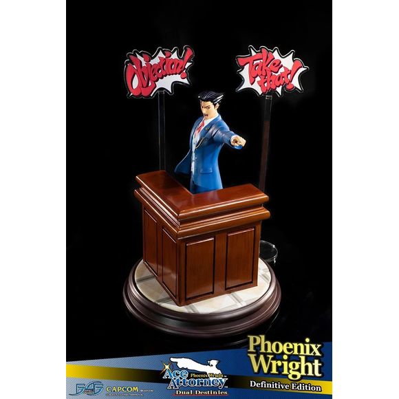 This statue has no edition number, and was a replacement and is in new and unopened condition. Phoenix Wright: Ace Attorney - Dual Destinies - Phoenix Wright DEFINITIVE edition comes with the following:- 

Phoenix Wright: Ace Attorney - Dual Destinies - Phoenix Wright RESIN statue
Highly detailed base capturing the theme and style from the courtroom in Phoenix Wright: Ace Attorney - Dual Destinies
Additional large base featuring the defense bench
TWO acrylic speech bubbles, "OBJECTION!" and "TAKE THAT!" fro