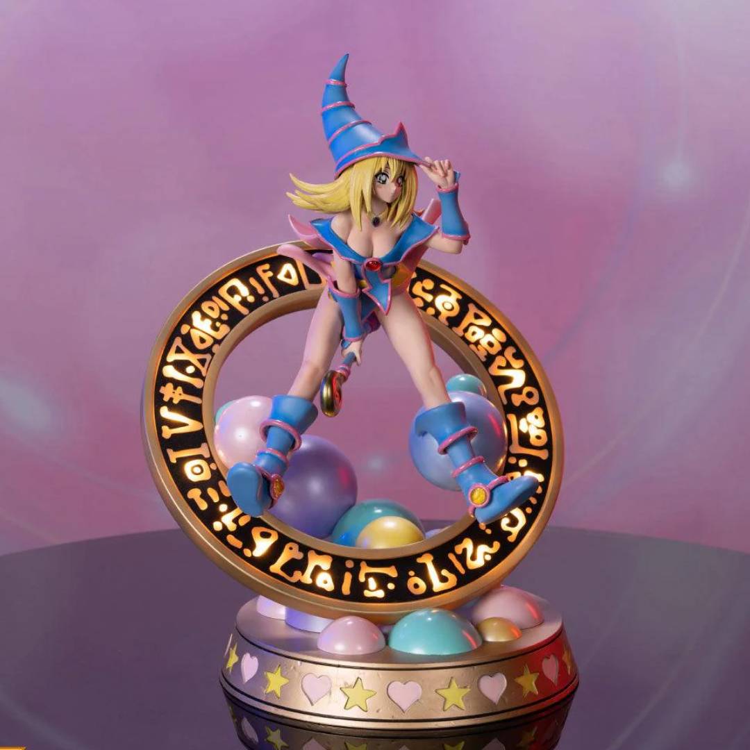 This statue has no edition number, and was a replacement and is in new and unopened condition. 

The “Pastel” variation features Dark Magician Girl wearing a light blue dress accented by light pink details. For the exclusive edition, the Magician’s seal lights up with 2 LED functions: Static and Animated. When animated, lights swirl around the ring of the Seal as if Dark Magician Girl is preparing to use her Dark Burning Attack!