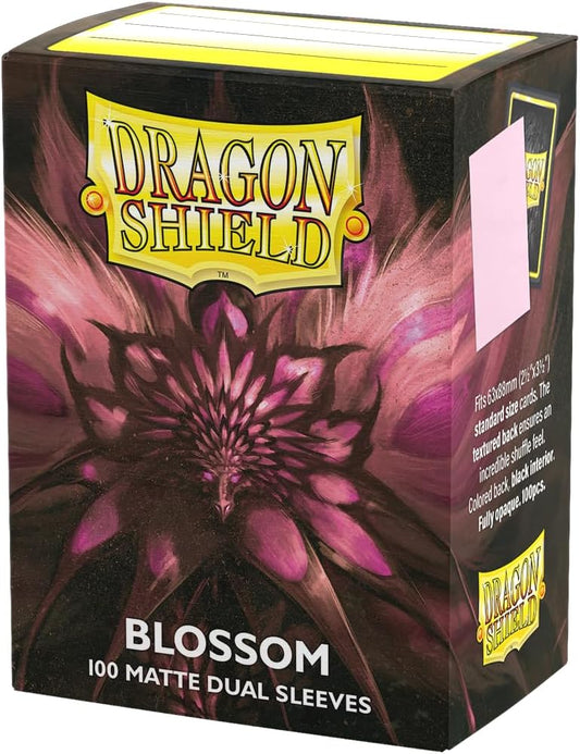 Dragon Shield Standard Matte Dual sleeves have a clear front and a textured matte back. They are fully opaque, with a black interior, which makes for an elegant backdrop for black bordered cards.
The sturdy cardboard box fits 75+ single sleeved cards or 65+ double sleeved cards measuring up to 63 x 88 mm (2.5 x 3.5"), for games like MTG, Pokemon, Flesh and Blood, and Lorcana! Every box has a label at the top of the box for personalization.