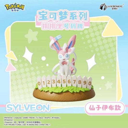 Add a touch of Fairy-type charm to your collection with this adorable Sylveon Number Plate Display Figure by Langbowang! Featuring the beloved Intertwining Pokémon posed gracefully behind a decorative white picket fence, this collectible combines Sylveon's elegant design with a fun number display feature for a unique and eye-catching presentation.

Beautifully sculpted with Sylveon's signature pastel pink-and-blue ribbons, bows, and expressive eyes, this figure sits atop a colorful garden-themed base that b