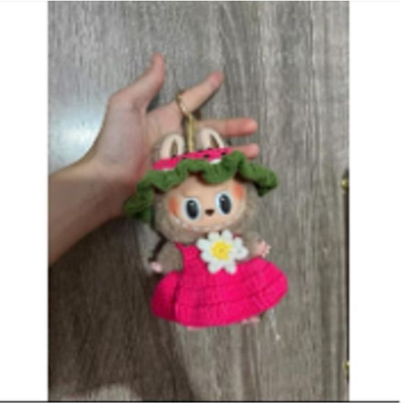 Outfit includes a Watermelon hat and pink sun dress with a flower on it perfectly designed to fit your favorite Labubu. Customize and accessorize yours today! Labubu and accessories not included.