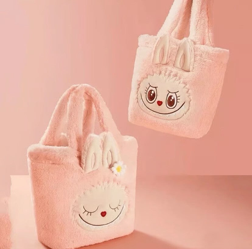 This Mokoko Sweetheart Reversible Plush Tote feels like something straight out of a fairytale. Soft, fuzzy, and irresistibly sweet, this official POP MART release was available only through POP LAND Beijing and comes brand new with original tags.

One side shows Mokoko fast asleep, with closed eyes, a heart shaped nose, and a tiny daisy resting gently by her face. Flip the bag inside out and she wakes up smiling, bright eyed and cheerful. It truly feels like carrying two moods in one bag, dreamy and cozy on