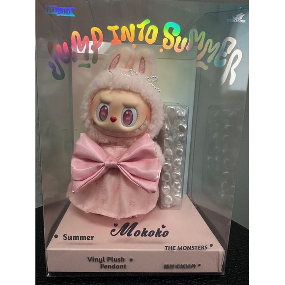 Embrace the warmth of summer with the Pop Mart Mokoko Jump Into Summer Vinyl Plush Pendant. This delightful accessory features Mokoko, the beloved character from Pop Mart's "The Monsters" series, dressed in a charming bunny-themed outfit. With its soft pink hues and playful design, this pendant captures the essence of sunny days and playful adventures.  Approximately 18cm in height.  Authentic.