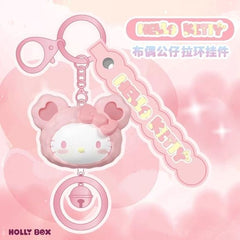 Add a touch of kawaii charm to your everyday essentials with this adorable Hello Kitty Bear Hoodie Keychain from Holly Box! Featuring Hello Kitty dressed in a cute pink bear-eared hoodie, this stylish accessory combines sweet pastel colors with playful details that Sanrio fans will love.

The keychain includes a matching "HELLO KITTY" charm tag, a sturdy metal key ring, and a decorative dangling bell accent that adds extra personality to the design. Lightweight yet eye-catching, it's perfect for attaching t
