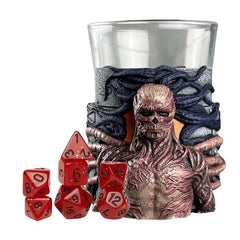 Bring the Upside Down to your gaming table with Stranger Things Mini Dice Cups- a must-have for RPG fans and Stranger Things collectors alike. Made from glass and featuring detailed sculpts of iconic creatures and themes from the hit Netflix series, these mini dice cups combine style, function, and fandom. Each cup comes paired with a complete 8-piece mini polyhedral dice set, perfect for your favorite tabletop RPG. Inside, you'll find:d4 x 1d6 x 1d8 x 1d10 x 1d12 x 1d% x 1d20 x 2Choose from four collectibl
