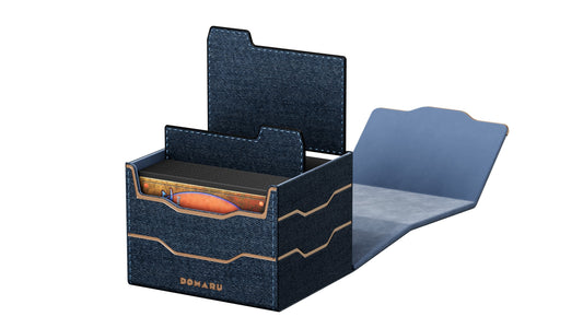 The DOMARU Armory Collection is our latest deck box line, built for strength, durability, and a commanding presence at the table. Featuring refined metallic details, a rugged textured exterior, and strong magnetic closures, each Armory box delivers uncompromising protection for serious play. Side Loading. Fits 100 double-sleeved cards. Includes 2 leather dividers. Strong Magnets. Sturdy textured leather materials and metallic details.